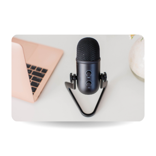 There is a laptop and a professional microphone next to it