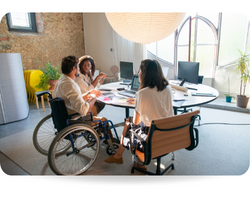 People having a meeting at the office. One of the colleagues is in a wheelchair