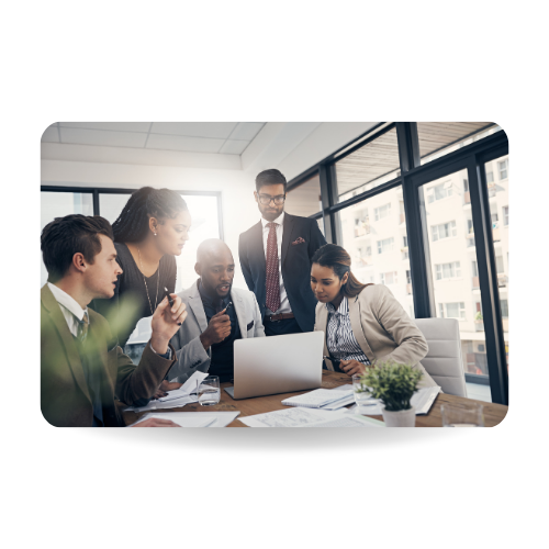 Shot of a group of young business people using a laptop together during a meeting in a modern office.
